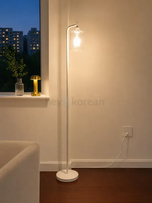 White floor lamp with a clear glass shade in Brooklyn, NY